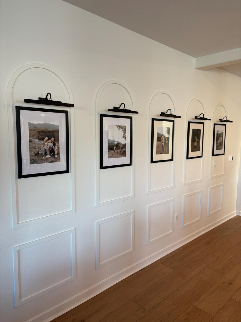 real home accent wall created with DIY arched MDF wall molding trim kit-Row of framed pictures on a wall with decorative arches