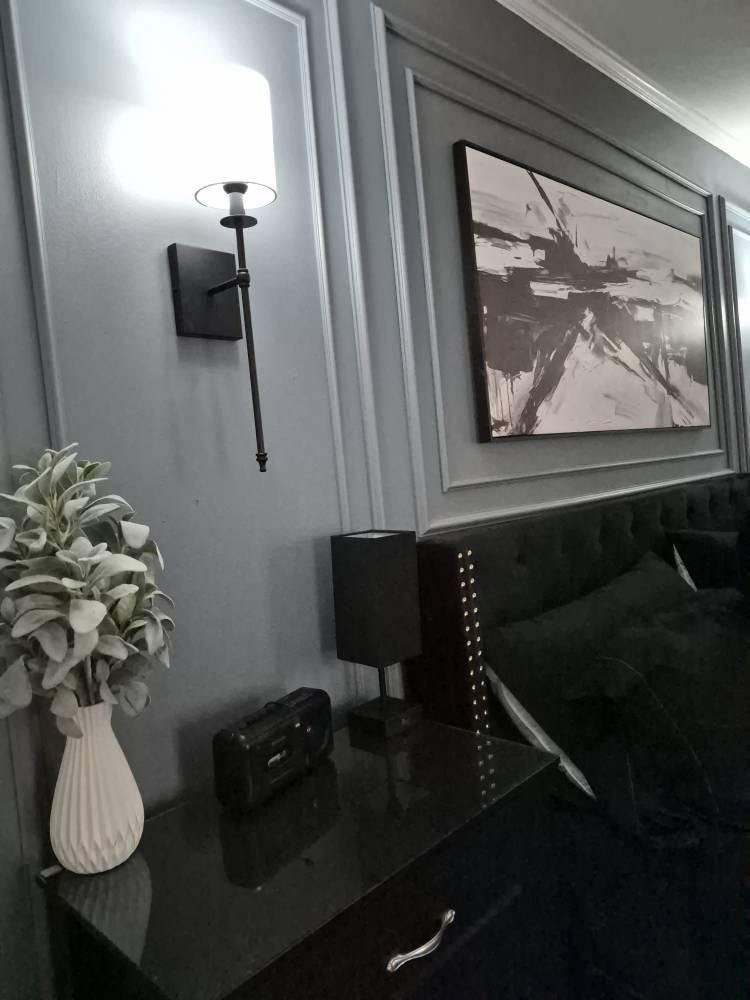 bedroom accent wall with wall molding installed behind bed by customer