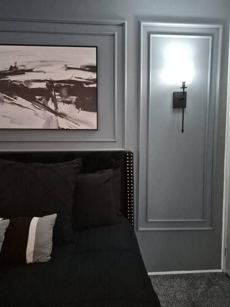 bedroom accent wall with wall molding installed behind bed by customer