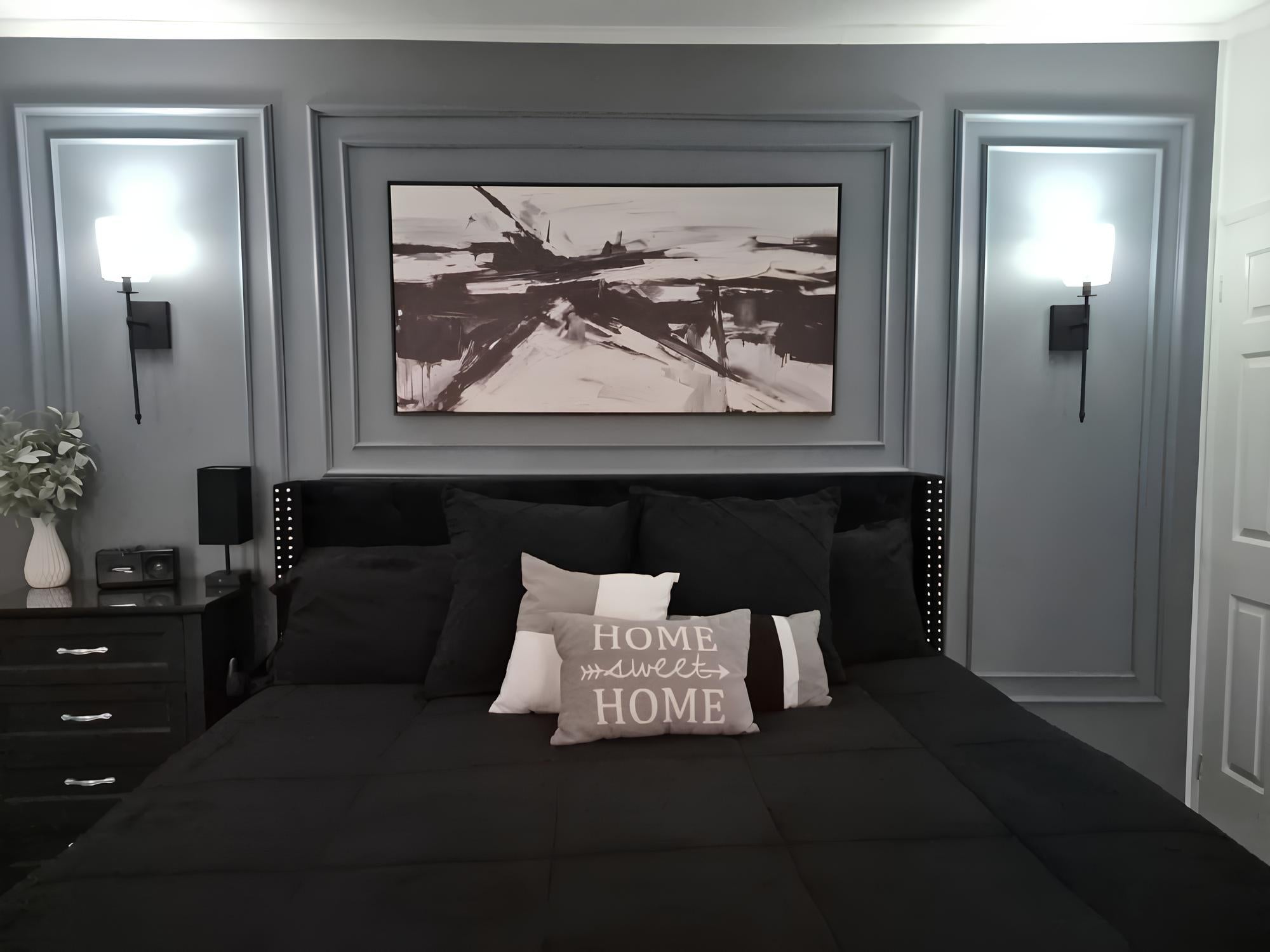 bedroom accent wall with wall molding installed behind bed by customer