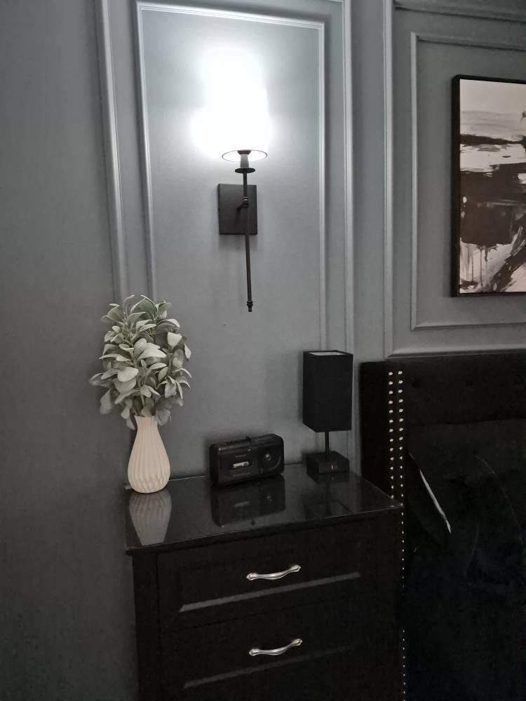 bedroom accent wall with wall molding installed behind bed by customer