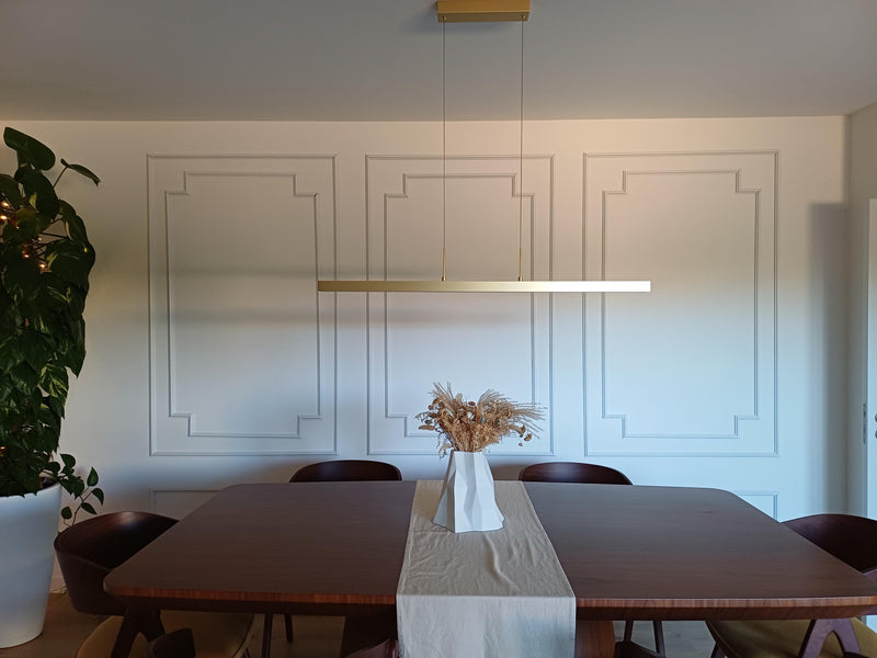 decorative wall molding panels creating elegant dining room accent wall-Dining room with a table, chairs, and decorative elements.