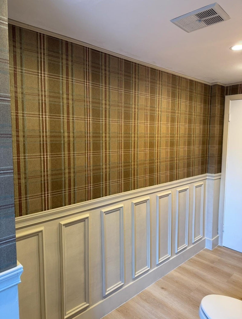 DIY half of wall molding panel design completed in modern bathroom -Wall with plaid wallpaper and wainscoting in a room.