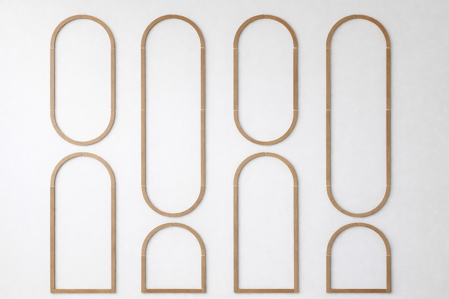 Pre-cut MDF arched wall molding kit pieces arranged for easy DIY wall panel installation