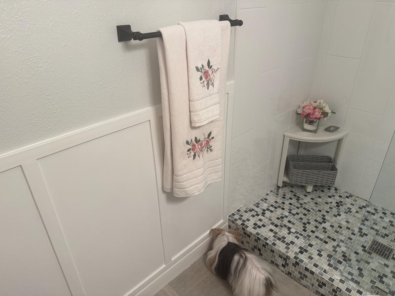customer installed shaker board and batten wall molding kit showing finished panel wall design-Bathroom with towels hanging on a rack and a small table with flowers.