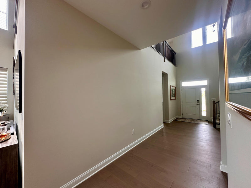 Empty room with wooden floor and white walls