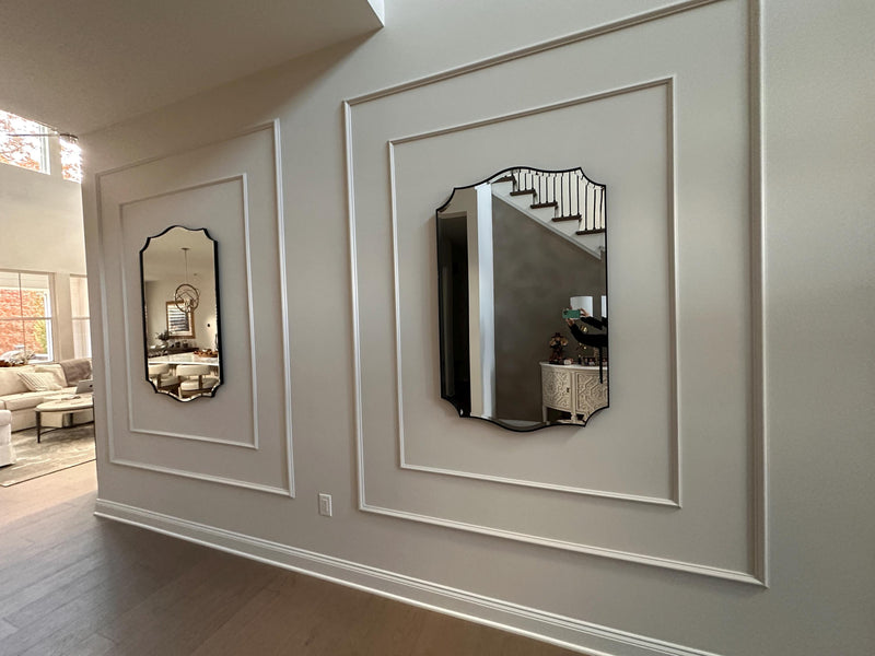  decorative wall molding panels creating an elegant accent wall-Decorative wall mirrors with white frames on a light gray wall.