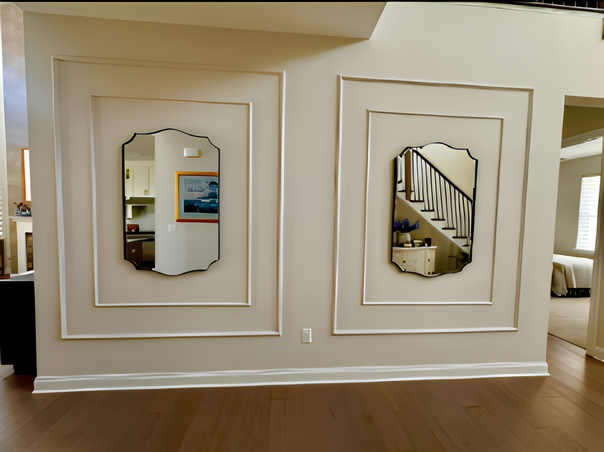 decorative wall molding panels creating an elegant accent wall- Two wall mirrors framed in white on a beige wall with wooden flooring.
